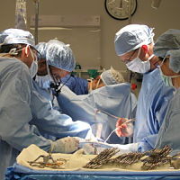 This is a picture of a surgical staff operating on a patient.