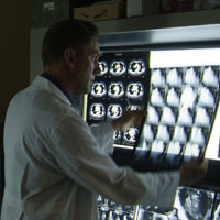 This is a picture of a doctor looking at xrays.